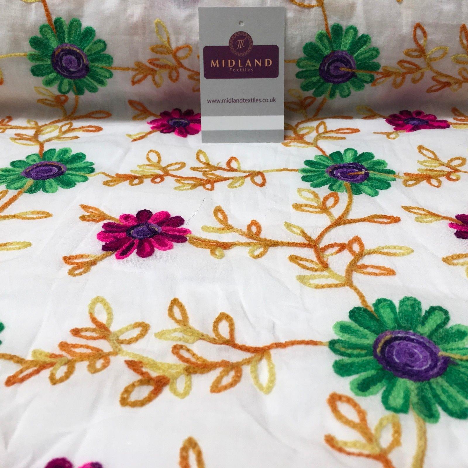 White Cotton with multicoloured wool embroidered dress fabric 54" Wide M1000